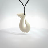 Hand carved bone hook pendant. This piece is carved with a winged decoration on the upper part. We've named it 'Avenger' after the Goddess Nike. Shipping is free worldwide.